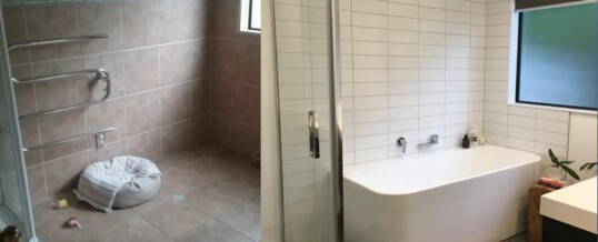 Tiled bathroom with freestanding back to wall bath